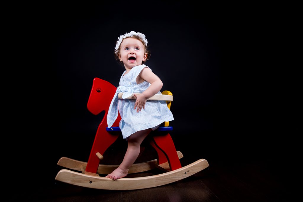 η μικρή πάνω σε ξύλινο αλογάκι