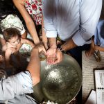 τα χέρια του νονού με το λάδι, ο μικρός στα χέρια της μητέρας του.